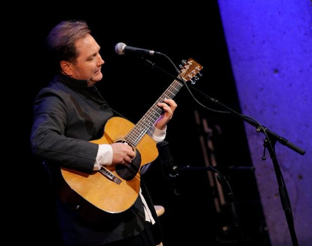 Steve Wariner, CGP playing acoustic guitar on stage