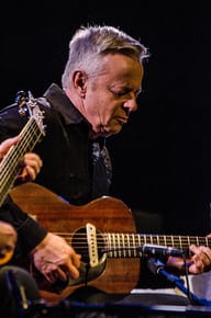 Tommy Emmanual playing his signature acoustic guitar.