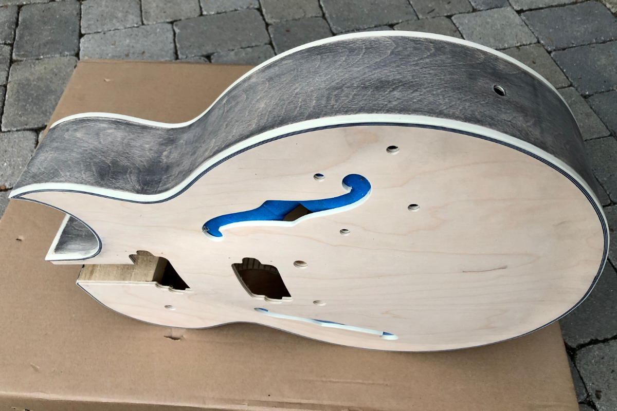 Screwed up woodgrain filler on the guitar.